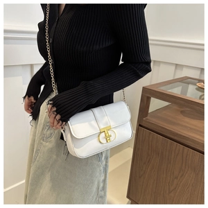 Detail of a white square shoulder bag with gold double-ring buckle and fine chain strap