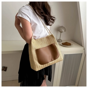 Vintage straw tote bag with brown leather pocket and woven rope handles for summer beach style