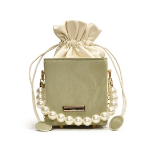 Elegant sage green bucket bag with large pearl handle and drawstring closure