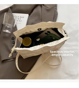 Top view of spacious quilted bucket bag interior showing room for phones and cosmetics