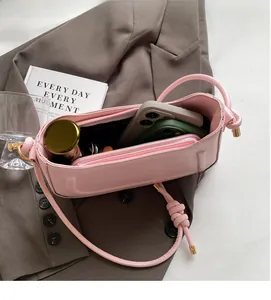 Detail view of pink saddle bag interior showing spacious compartments for phone and makeup