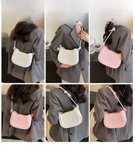 Model showcasing white and pink minimalist underarm bags with decorative knotted straps