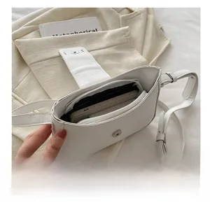 Interior view of white baguette bag showing large capacity and inner zipper pocket