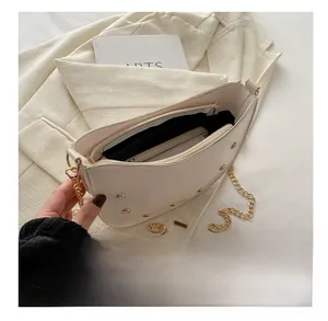 Internal view of a white chain saddle bag showing capacity for phone and wallet
