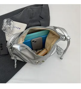 Interior view showing large capacity of the silver leather bucket bag with tablet and phone
