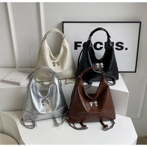 Fashionable versatile bucket bags in cream, black, silver, and brown with bow detail
