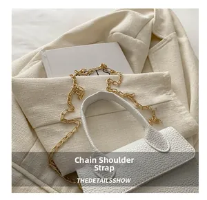 Close-up of white caviar texture mini handbag with elegant gold metal chain strap