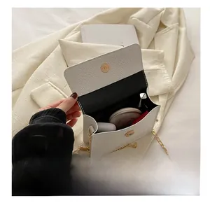Litchi pattern white chain bag interior showing storage for lipstick and cushion compact