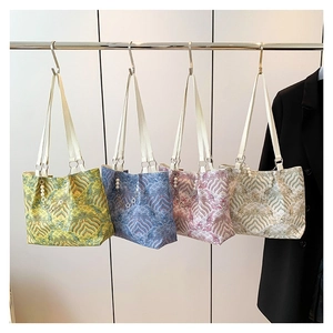 Elegant wave pattern tote bags with bamboo handles and pearl charms in four colors