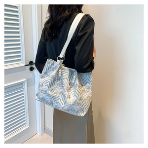 Elegant vintage embroidered tote bag with wave patterns and bamboo style handle for women