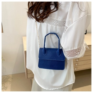 Close-up of blue lychee pattern mini crossbody bag with gold chain and top handle