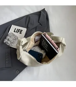Interior view of off-white leather tote bag showing spacious room and silver zipper