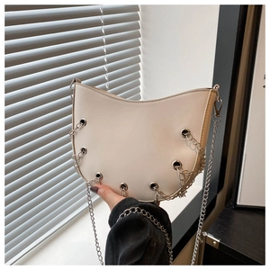 Chic beige half-moon punk handbag with silver rivets and metallic chain straps