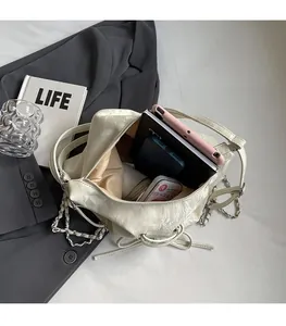 Spacious beige crossbody bag showing interior capacity for tablets and mobile devices