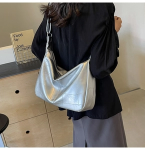 Detail of silver metallic leather tote bag featuring a geometric stitching pattern