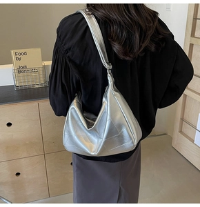 Detail of silver metallic hobo bag with geometric quilting and soft texture