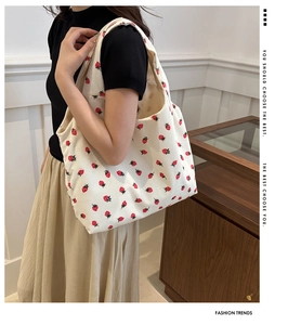 Detail of corduroy tote bag with strawberry print showing the soft fabric texture