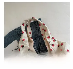 Close-up of strawberry print corduroy tote showing durable handle stitching and soft texture