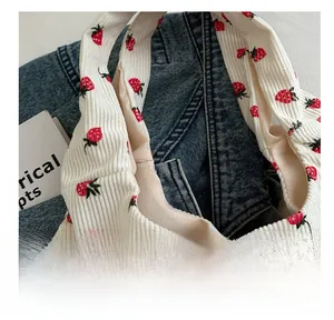 Detail view of durable stitching on white corduroy strawberry tote bag handles