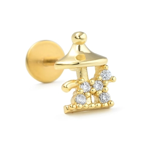 Detail of golden carousel labret stud with white zircons and flat back screw design