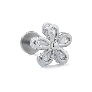 Macro detail of silver labret stud featuring a five-petal flower set with clear zircons