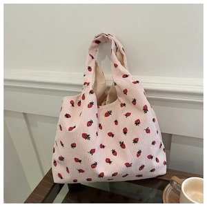 Pink corduroy tote bag with strawberry embroidery and soft vertical ribbed texture