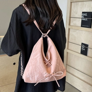 Pink triangular backpack with lace-up ribbon detail and chain strap for women