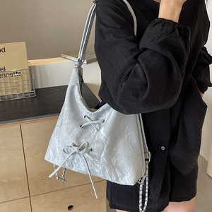 Silver wrinkled metallic shoulder bag with bow details and chain strap decoration