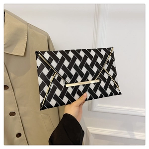 Fashionable black and white woven envelope clutch bag with elegant gold metal buckle