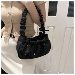 Detailed shot of black denim cloud bag with colorful beads and ruched design