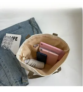 Spacious canvas tote interior showing capacity for tablets, phone and umbrella