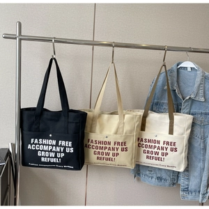 Minimalist canvas tote bag with outer pockets in black, khaki and off-white colors
