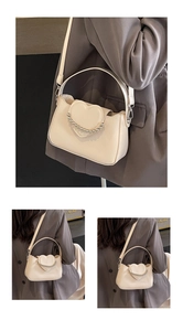 Detail of cream PU leather shoulder bag with heart accent and silver bead chain trim