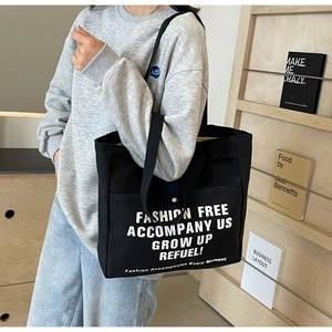 Large capacity black canvas tote bag with letter print and front button pocket for women