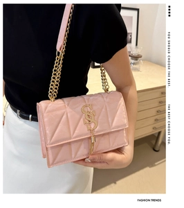 Pink quilted square crossbody bag featuring a gold chain strap and stylish long tassel