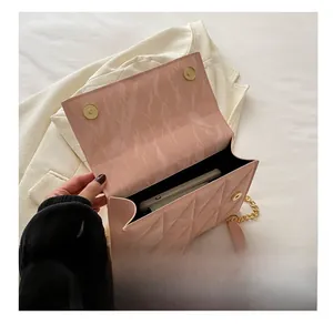 Internal view of pink quilted chain bag showing capacity for a smartphone