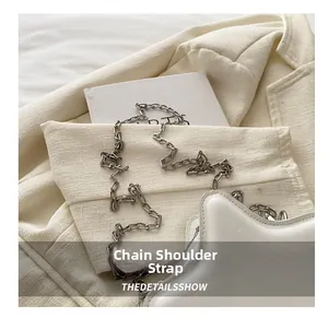 Detailed close-up of a white star-shaped bag with a silver chain strap and matte PU leather