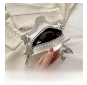 Macro shot showing internal capacity of the white star-shaped bag with makeup items