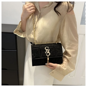Quilted black velvet chain shoulder bag with gold double S logo and tassel detail