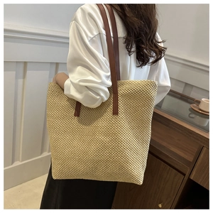 Minimalist beige woven straw tote bag with brown leather shoulder straps for women