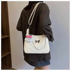 Minimalist white leather shoulder bag with silver butterfly charm and chain detail