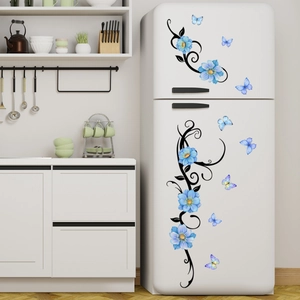 Blue flower and butterfly decorative wall stickers applied on a white refrigerator