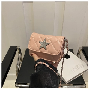 Detail of a pink quilted mini bag with a sparkling diamond-set star and silver chain