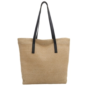 Large woven straw tote bag with black leather straps on a white background for summer