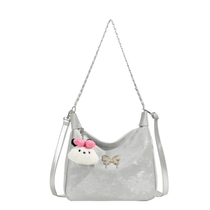 Metallic silver minimalist shoulder bag with bow charm and plush bunny keychain