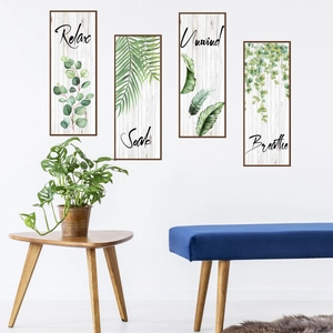 Close-up of four minimalist green leaf art prints with Relax Soak Unwind Breathe text