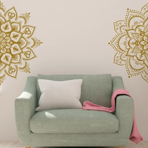 Detail of golden mandala wall stickers in a cozy living room with a mint green sofa