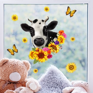 Detail of cow, sunflowers, and butterflies static window stickers on a bright glass pane