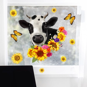 Detailed view of cow, sunflowers and butterfly stickers on a glass window surface