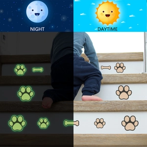 Luminous dog paw and bone wall stickers showing glowing effect on indoor stairs at night